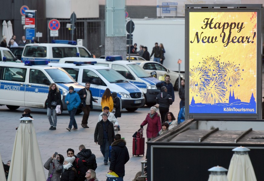 epa05691734 A &#039;Happy New Year&#039; sign is on display near parked police vehicles in front of the Cologne central station in Cologne, Germany, 30 December 2016. As a result of the mass sexual as ...