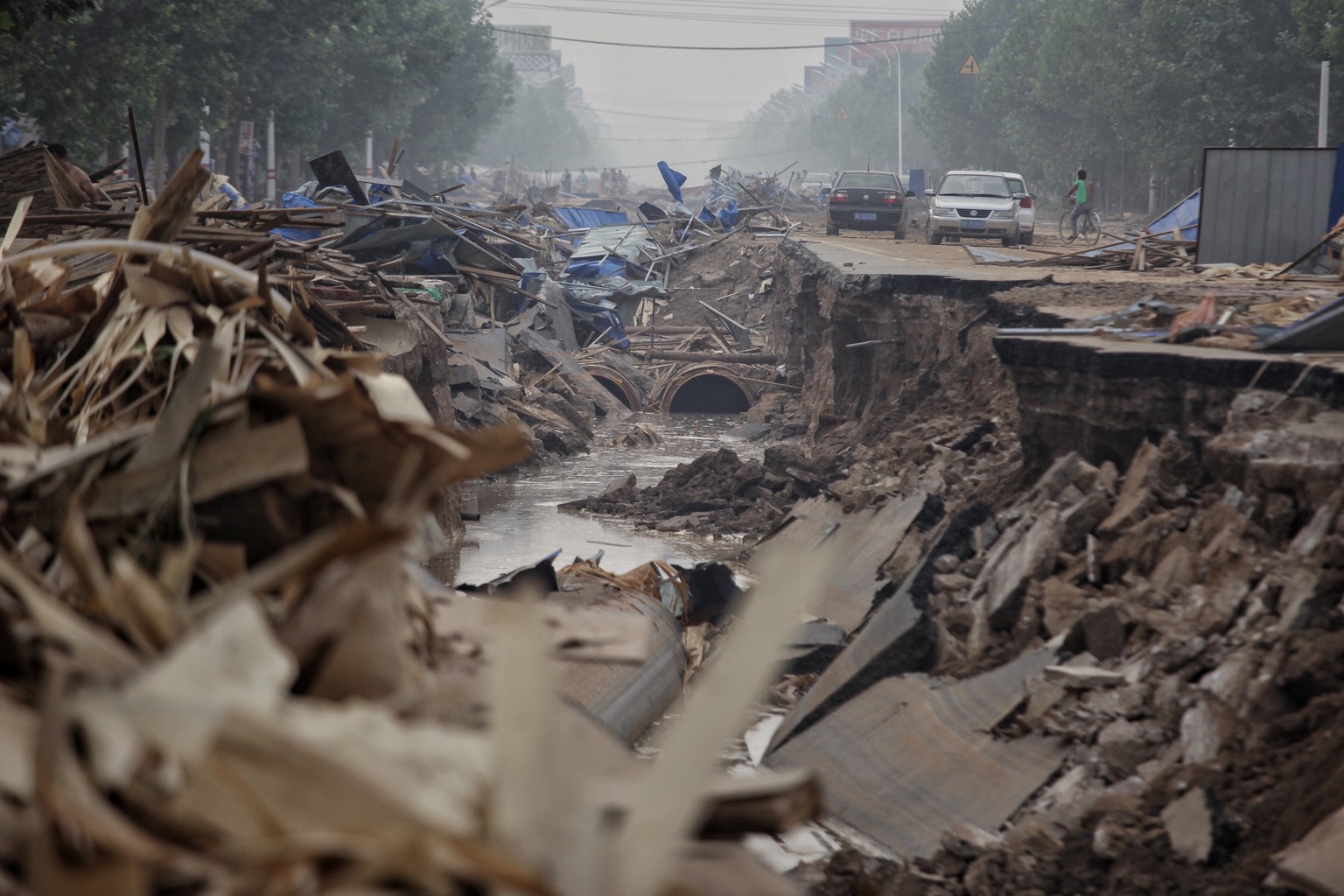 A road is seen damaged after floods in Xingtai, Hebei Province, China, July 23, 2016. Picture taken July 23, 2016. China Daily/via REUTERS ATTENTION EDITORS - THIS IMAGE WAS PROVIDED BY A THIRD PARTY. ...