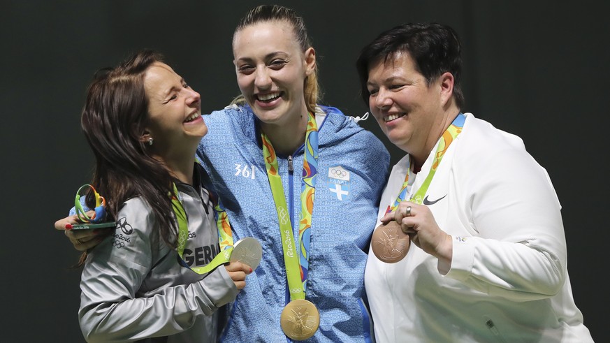 Gold medalist Anna Korakaki, center, of Greece is flanked by silver medalist Monika Karsch, left, of Germany and bronze medalist Heidi Diethelm Gerber, right, of Switzerland during the award ceremony  ...
