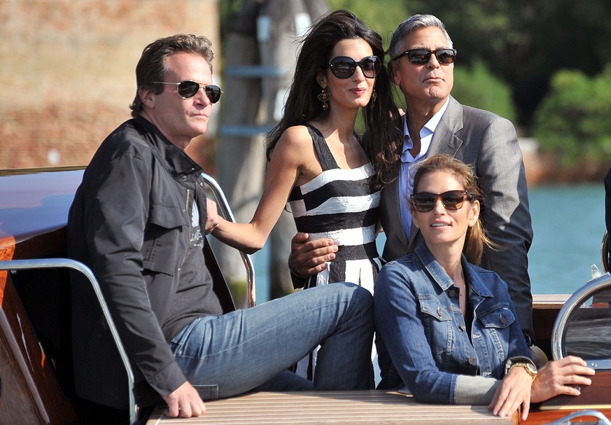 George Clooney, top right, his fiancee Amal Alamuddin, Cindy Crawford, bottom right and her husband Rande Gerber arrive in Venice, Italy, Friday, Sept. 26, 2014. George Clooney and his fiancee Amal Al ...
