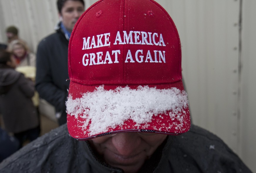 Snow collects on Dan Scheidel&#039;s hat as he waits to enter the DeltaPlex to hear President-elect Donald J. Trump to speak as part of his &quot;USA Thank You Tour&quot; in Walker, Mich., Friday, Dec ...