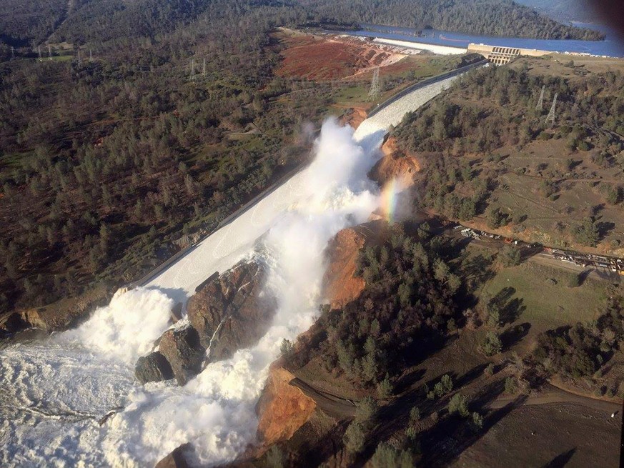 A damaged spillway with eroded hillside is seen in an aerial photo taken over the Oroville Dam in Oroville, California, U.S. February 11, 2017. California Department of Water Resources/William Croyle/ ...