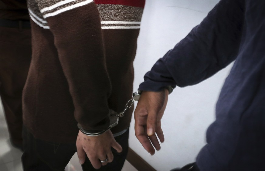 Two men accused of having gay sex are handcuffed as they arrive at the Shariah court in Banda Aceh, Indonesia, Wednesday, May 17, 2017. A Shariah court in Indonesia&#039;s conservative Aceh province h ...