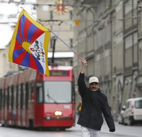 epa05718505 A protester waves a Tibetan flag on the streets of Bern, prior to the state visit of Chinese President Xi Jinping, in Bern, Switzerland, 15 January, 2017. President Xi is on a state visit  ...