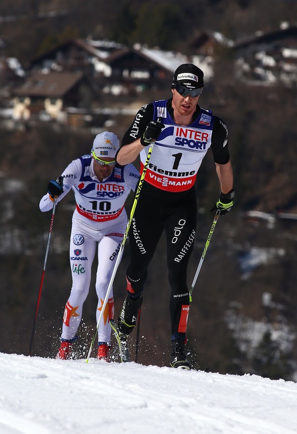 Dario Cologna, of Switzerland, leads Sweden&#039;s Johan Olsson during the men&#039;s 50-kilometer Classic Mass Start race, at the Nordic Ski World Championships in Val di Fiemme, Italy, Sunday, March ...