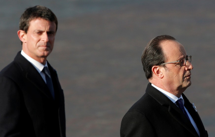 France&#039;s President Francois Hollande (R) and Prime Minister Manuel Valls review troops as they attend a commemoration ceremony for Armistice day, 98 years after the end of the First World War at  ...