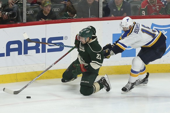Minnesota Wild&#039;s Nino Niederreiter (22) tries to maintain control of the puck against St. Louis Blues&#039; Jay Bouwmeester (19) during the third period of Game 2 of an NHL hockey first-round pla ...