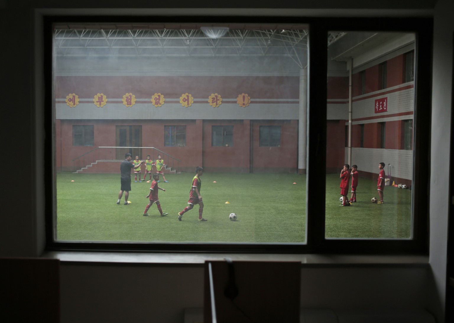 Children practice soccer at Pyongyang International Football School in Pyongyang, North Korea, Wednesday, Aug. 24, 2016. North Korea has poured funds into the development and training of promising ath ...