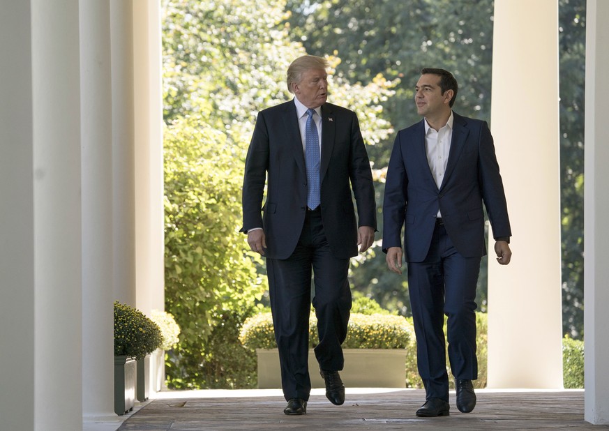 President Donald Trump and Greek Prime Minister Alexis Tsipras walk form the Oval Office as they arrive for a news conference in the Rose Garden of the White House in Washington, Tuesday, Oct. 17, 201 ...