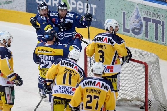 Ambri&#039;s player Adam Hall, Ambri&#039;s player Adrien Lauper and Ambri&#039;s player Diego Kostner, from left, celebrate the 3-2 goal, during the first league qualification ice hockey game of the  ...