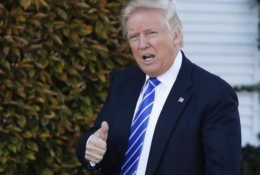 FILE - In this Saturday, Nov. 19, 2016 file photo, President-elect Donald Trump gives the thumbs-up as he arrive at the Trump National Golf Club Bedminster clubhouse in Bedminster, N.J. Los Angeles Ma ...