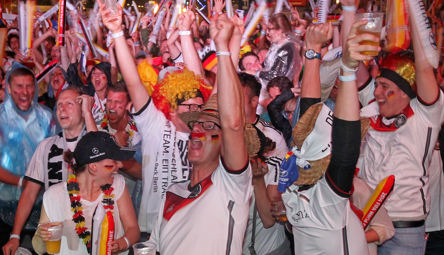 BERLIN, GERMANY - JULY 08: Fans of Germany celebrate during the 2014 FIFA World Cup Brazil semi final match between Brazil and Germany at the Fanmeile public viewing at Brandenburg Gate on July 8, 201 ...