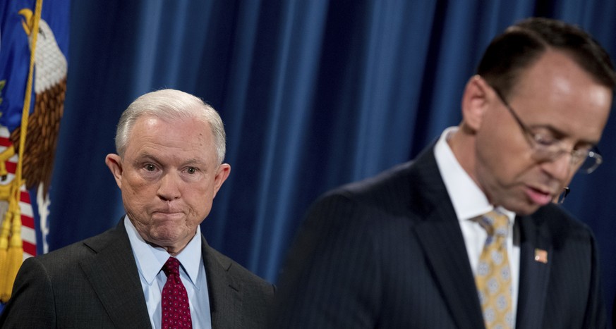 Deputy Attorney General Rod Rosenstein, right, accompanied by Attorney General Jeff Sessions, left, speaks at a news conference to announce an international cybercrime enforcement action at the Depart ...