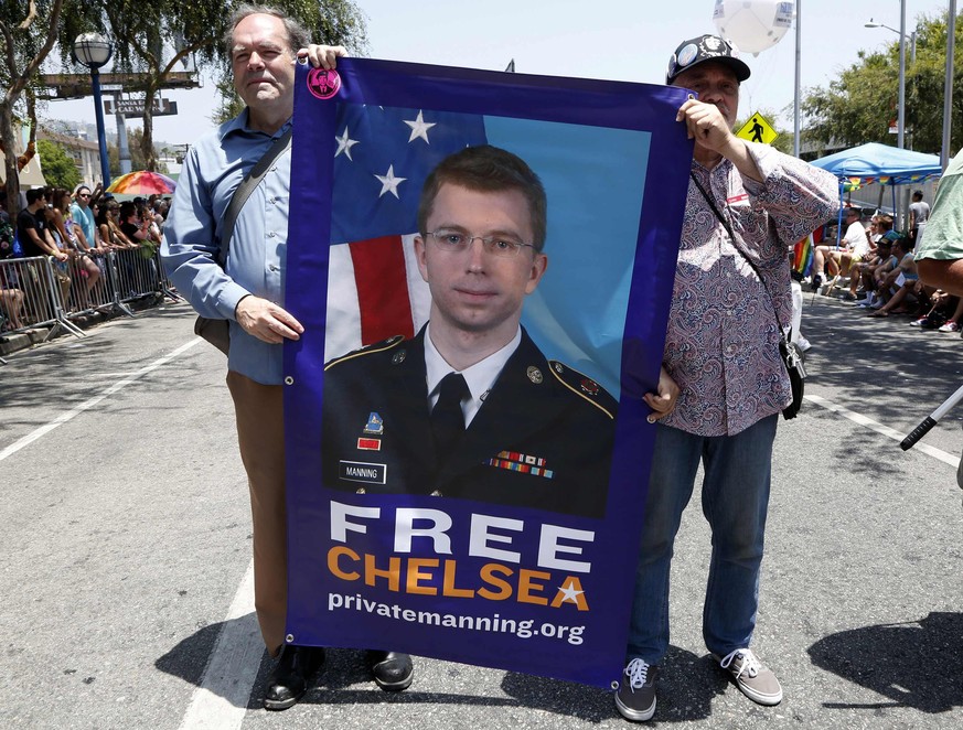 Men carry a sign urging freedom for convicted national security leaker Pvt. Chelsea Manning during the 44th annual Los Angeles Pride parade in West Hollywood, California June 8, 2014. Manning, formerl ...