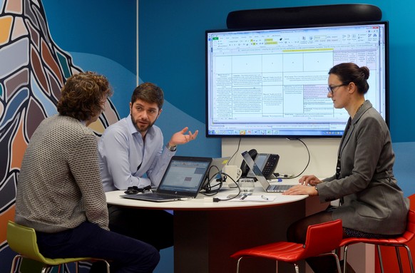 UBS employees work in the UBS &quot;fintech lab&quot; at Canary Wharf in London, Britain, October 19, 2016. REUTERS/Hannah McKay