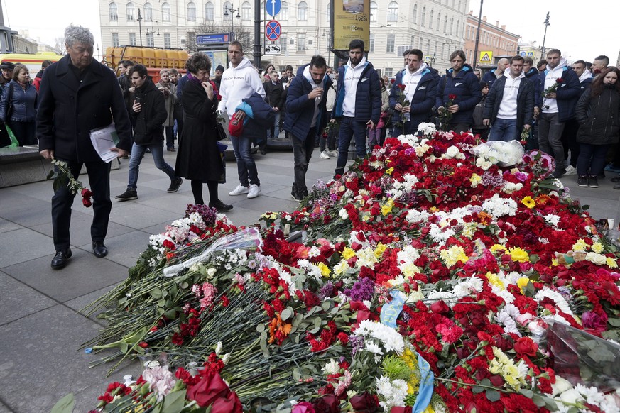 Zenit&#039;s St.Petersburg soccer club head coach Mircea Lucescu, left, and club players lay flowers at a symbolic memorial at Technologicheskiy Institute subway station in St. Petersburg, Russia, Apr ...