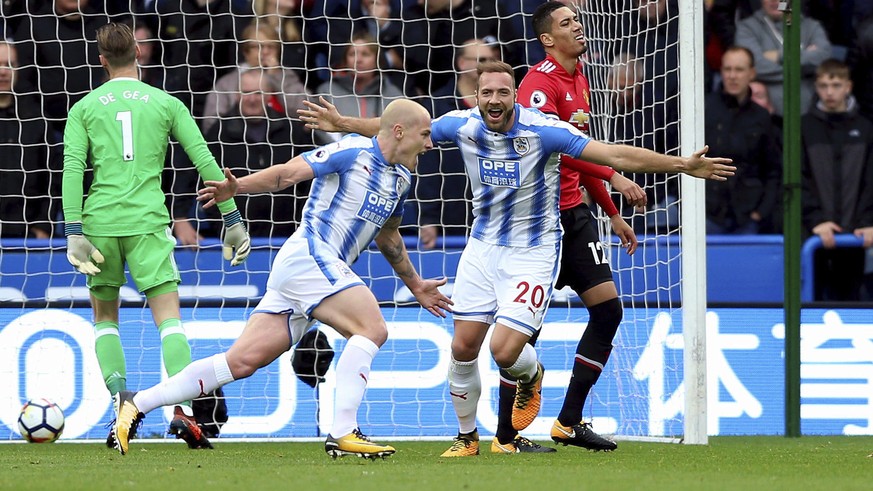 Huddersfield Town&#039;s Aaron Mooy, center, celebrates scoring his side&#039;s first goal of the game during the English Premier League soccer match between Huddersfield Town and Manchester United at ...
