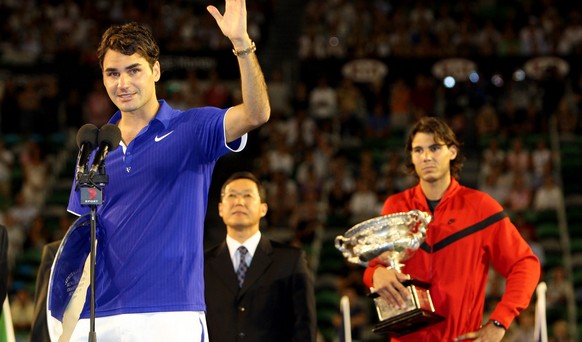 Runner-up Switzerland&#039;s Roger Federer, left, waves as Spain&#039;s Rafael Nadal holds the winner&#039;s trophy, during the awarding ceremony of the Men&#039;s singles final match at the Australia ...