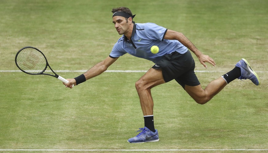 Switzerland&#039;s Roger Federer reaches for a shot during his match against Germany&#039;s Mischa Zverev at the Gerry Weber Open tennis tournament in Halle, Germany, Thursday, June 22, 2017. ( Friso  ...