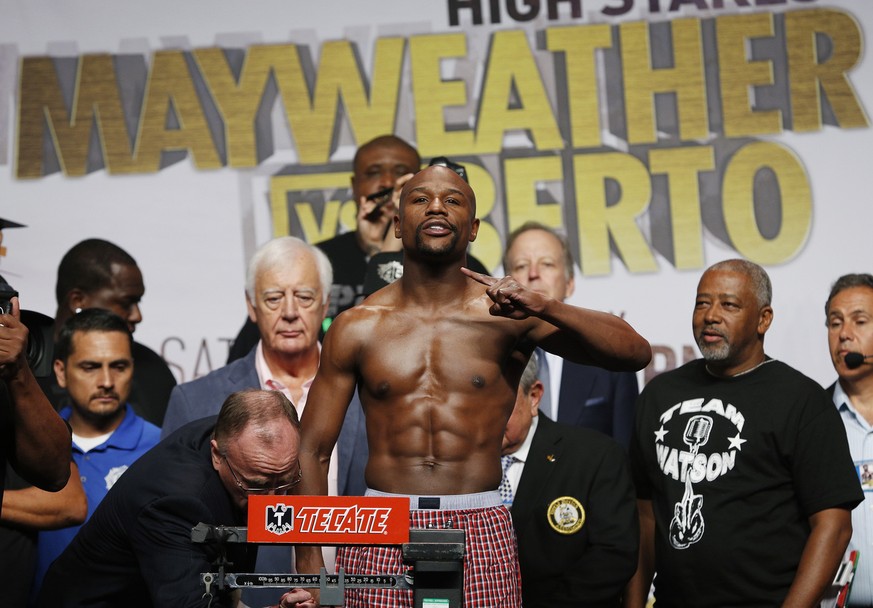 Floyd Mayweather Jr. poses on the scale during a weigh-in Friday, Sept. 11, 2015, in Las Vegas. Mayweather is scheduled to fight Andre Berto in a welterweight title bout Saturday in Las Vegas. (AP Pho ...