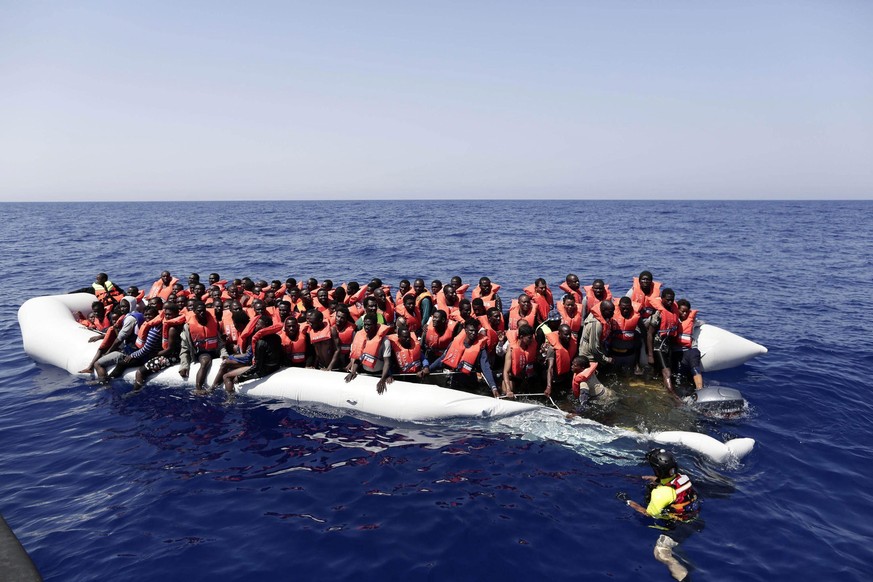 epa05496752 A handout picture taken and released by the Italian Red Cross shows migrants being rescued during the MOAS operation in which 304 migrants were rescued from a dinghy off the Libyan coast,  ...
