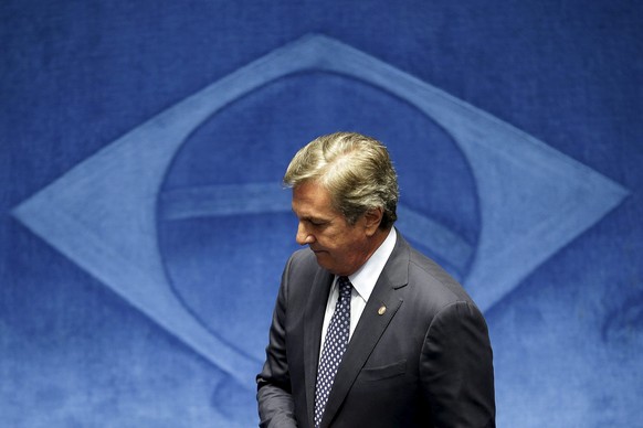 Brazilian Senator Fernando Collor de Mello walks during a session of the Brazilian Federal Senate in Brasilia July 14, 2015. Brazilian police carried out their first search and seizure operations on T ...