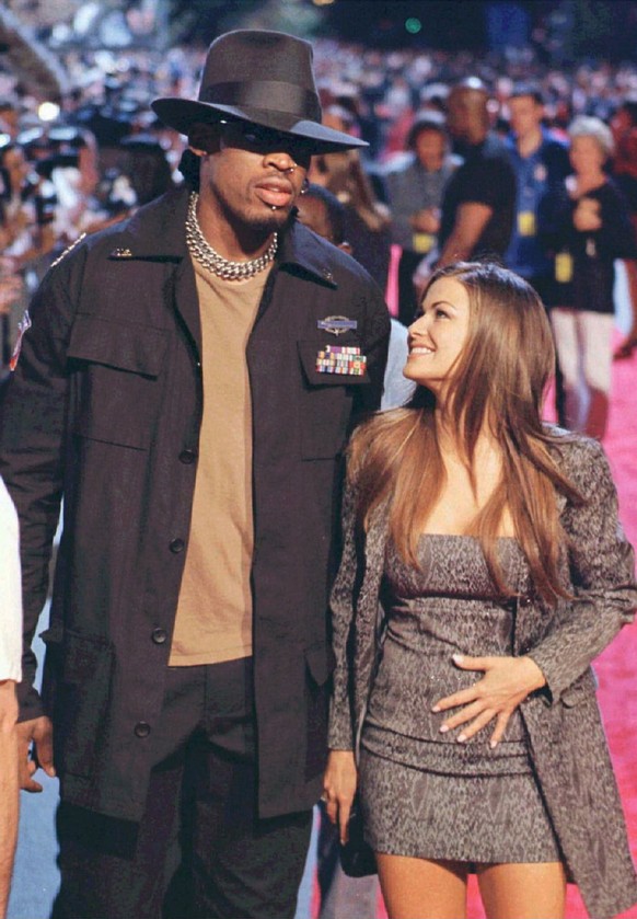 FILE--Chicago Bulls star Dennis Rodman and Carmen Electra, are shown arriving at the opening of the Planet Hollywood restaurant in this Montreal July 1998 file photo. The bad boy of the NBA confirmed  ...