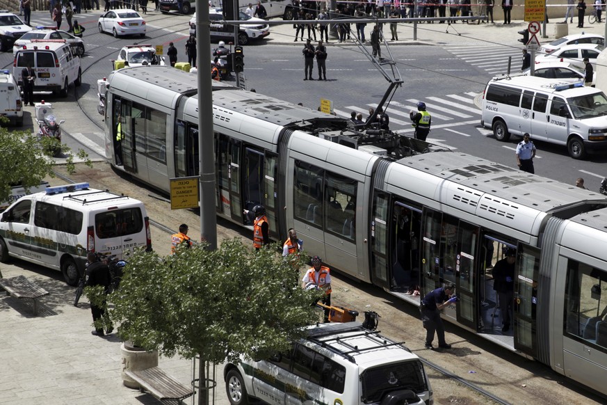 Emergency services and police are seen at the scene of an stabbing attack in Jerusalem Friday, April 14, 2017. A Palestinian stabbed a young British tourist to death in Jerusalem Friday near the Old C ...