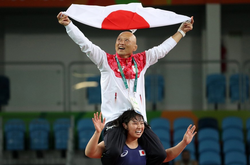 epa05494401 Sara Dosho (down) of Japan celebrates with her coach Kazuhito Sakae on her shoulders after winning the gold medal in women&#039;s Freestyle 69kg wrestling of the Rio 2016 Olympic Games Wre ...
