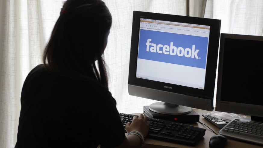 FILE - In this Monday, June 4, 2012, file photo, a girl looks at Facebook on her computer in Palo Alto, Calif. &quot;Fake news,&quot; which has gotten a lot of attention for its potential role in sway ...