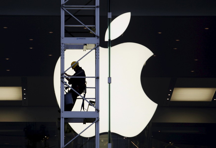 A worker climbs outside an Apple store in Hong Kong, in this April 10, 2013 file photo. China&#039;s &quot;Great Firewall&quot; may have been partly to blame for the first major attack on Apple Inc&#0 ...