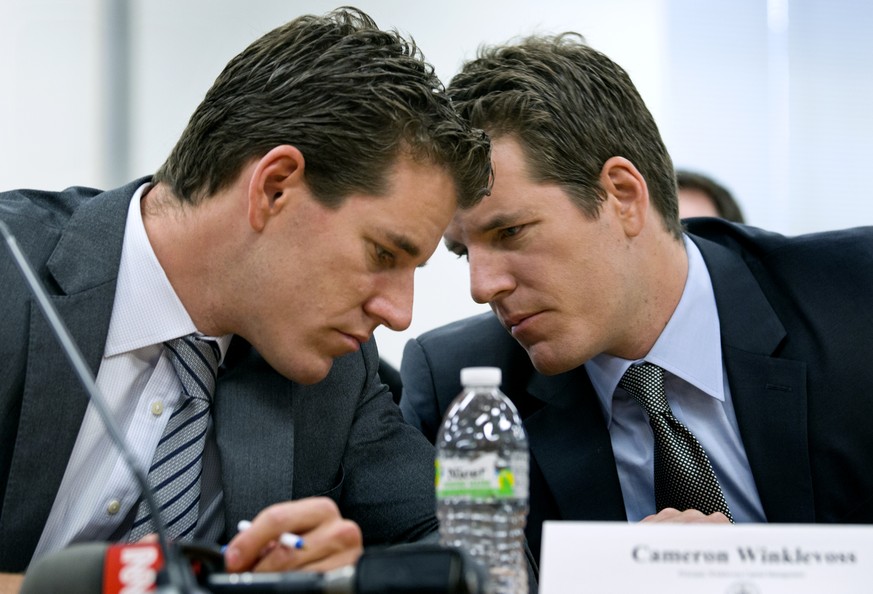 Brothers Cameron, left, and Tyler Winklevoss, Principals of Winklevoss Capital Management, share a word during a hearing called &quot;The Investor Perspective: The Future of Virtual Currencies&quot; i ...