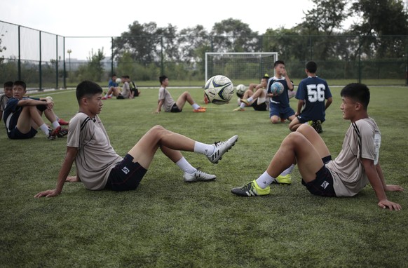 Youths play with a ball during a break at Pyongyang International Football School in Pyongyang, North Korea, Wednesday, Aug. 24, 2016. North Korea has poured funds into the development and training of ...