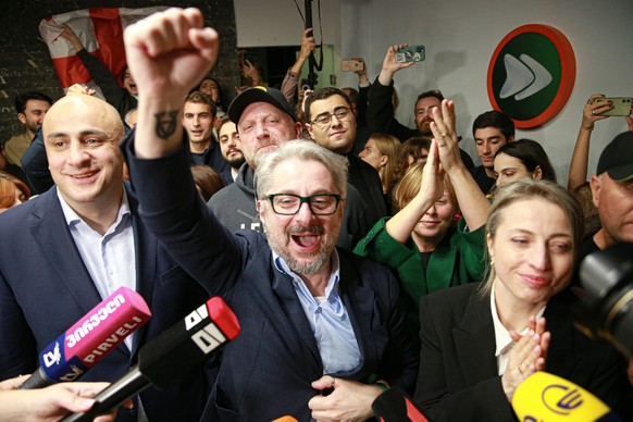Nachrichten Linkding From left, Nika Melia, Nika Gvaramia, leaders of Coalition for Changes, and Nana Malashkhia, who leads the Coalition for Change parliament list, react while talking to journalists at coalition's  ...