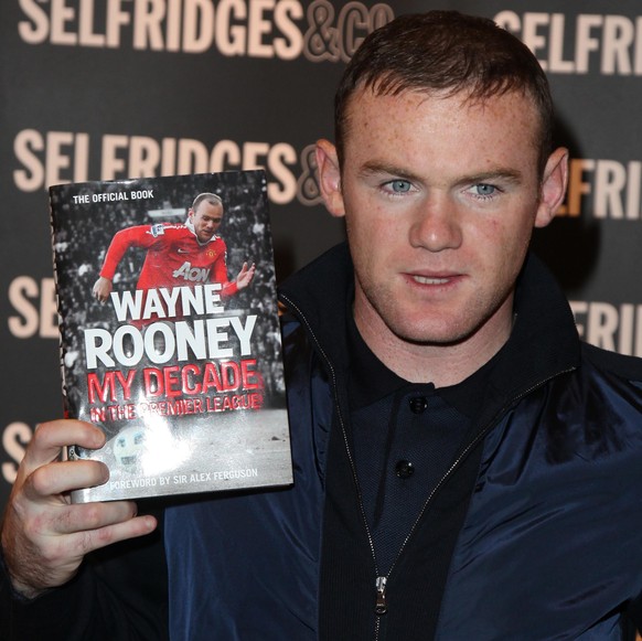 MANCHESTER, UNITED KINGDOM - OCTOBER 25: Wayne Rooney poses with a copie of his book &#039;My Decade in the Premier League&#039; at Selfridges Trafford Centre at WHSmith Manchester on October 25, 2012 ...