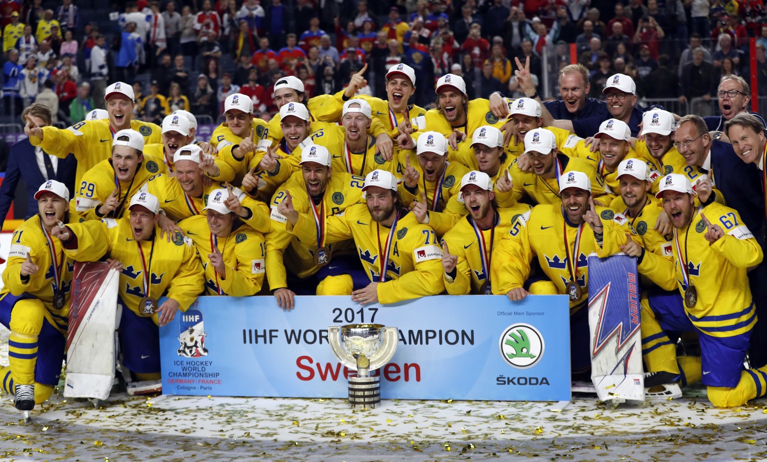 Sweden players celebrate their victory in the Ice Hockey World Championships final match between Canada and Sweden in the LANXESS arena in Cologne, Germany, Sunday, May 21, 2017. (AP Photo/Petr David  ...