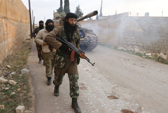 Members of al Qaeda&#039;s Nusra Front carry their weapons as they walk near al-Zahra village, north of Aleppo city, November 25, 2014. Members of al Qaeda&#039;s Nusra Front and other Sunni Islamists ...