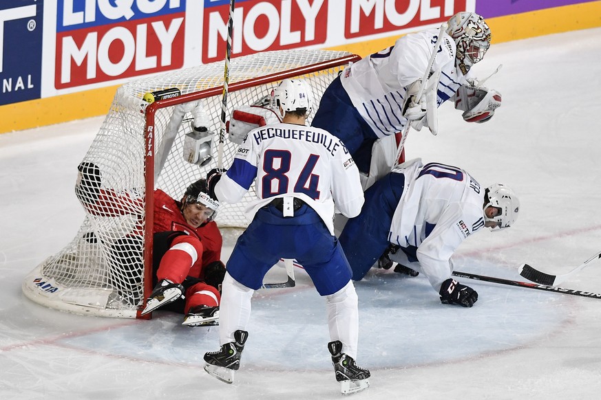 Switzerland’s Damien Brunner, left, in action against France’s Kevin Hecquefeuille, France’s goaltender Christobal Huet and France’s Laurent Meunier, from left, during their Ice Hockey World Champions ...