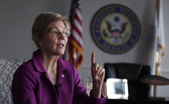 Sen. Elizabeth Warren, D-Mass. gestures as she answers a question during an interview at her office in Boston, Thursday, Dec. 15, 2016. (AP Photo/Charles Krupa)