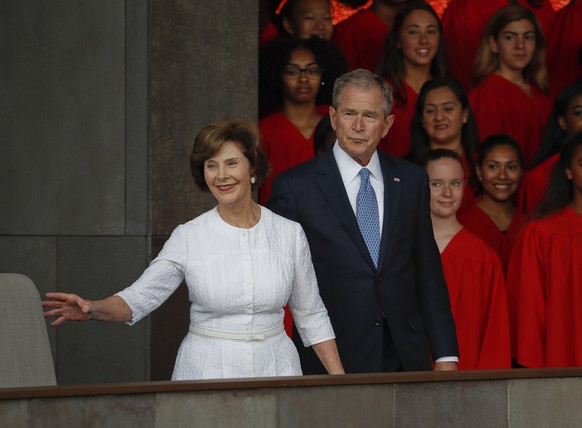 In this photo taken Sept. 24, 2016, former President George W. Bush and former first lady Laura Bush are seen in Washington. Falling in line with tradition, Bill and Hillary Clinton plan to attend Don ...