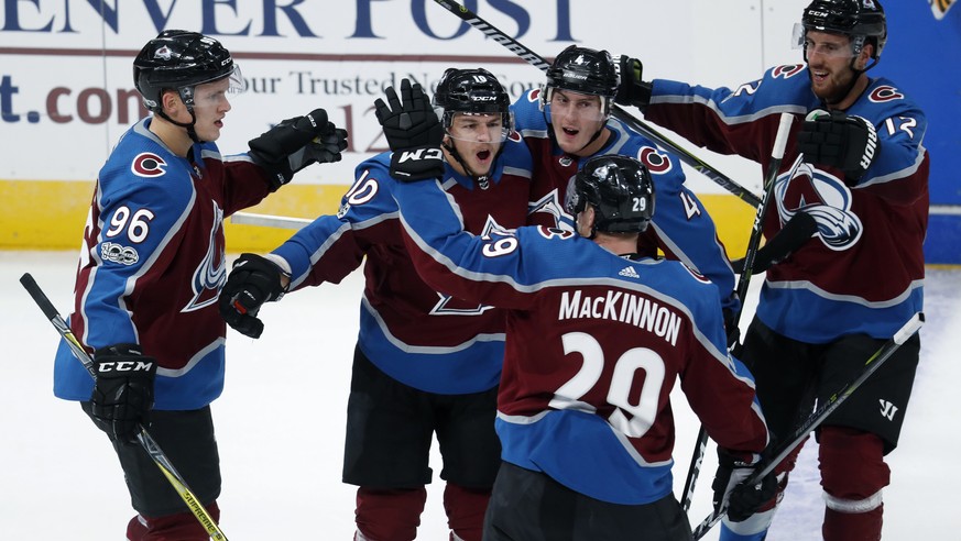 Colorado Avalanche right wing Sven Andrighetto, second from left, of Switzerland, celebrates his empty-net goal against the Boston Bruins with teammates, from left, right wing Mikko Rantanen, of Finla ...