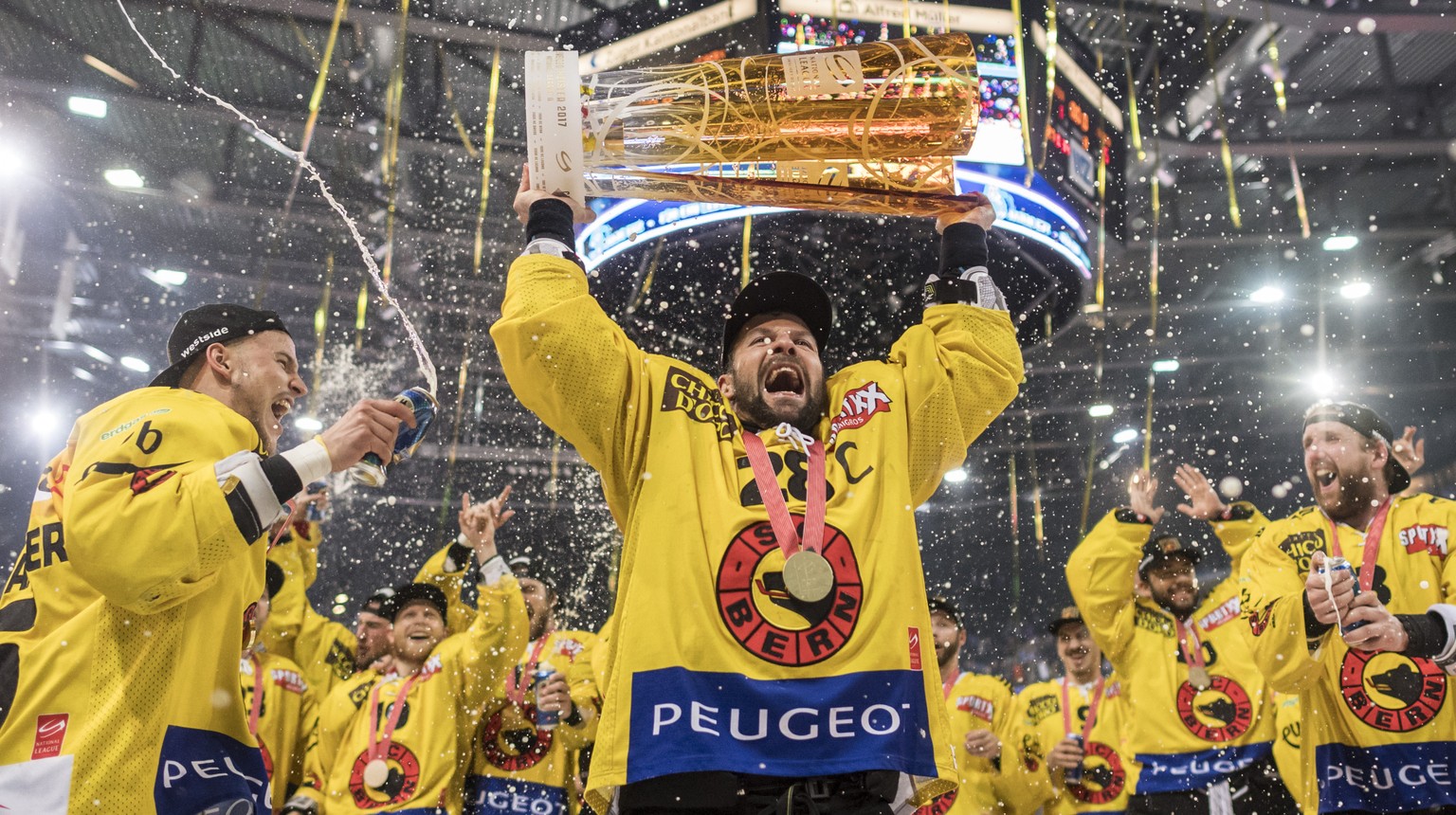 Der Berner Captain Martin Pluess, Mitte, stemmt den Meisterpokal und feiert mit seiner Mannschaft als Eishockey Schweizermeister nach demsechsten Eishockey Playoff-Finalspiel der National League A zwi ...