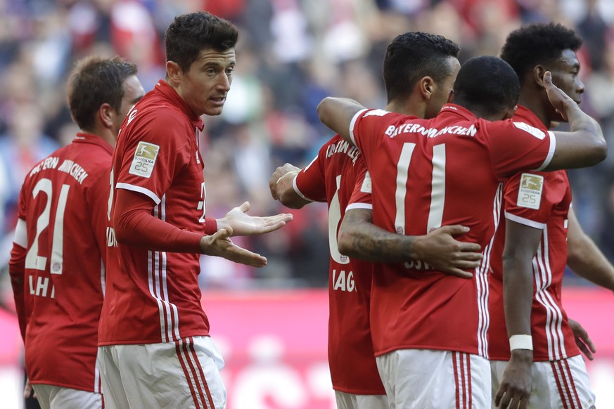 Bayern&#039;s Robert Lewandowski celebrates with team mates after scoring his side&#039;s opening goal during the German Bundesliga soccer match between FC Bayern Munich and Eintracht Frankfurt at the ...