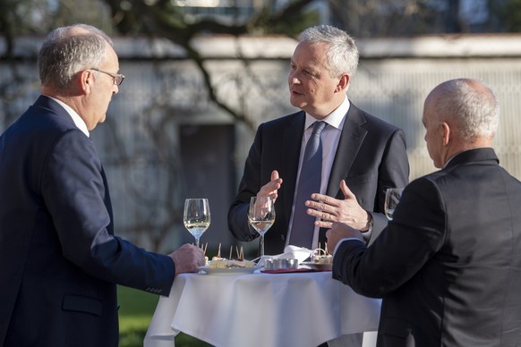 Swiss president Guy Parmelin, left, and federal councillor Ueli Maurer, right, welcome French economy and finance minister Bruno Le Maire, Center, for a bilateral meeting in Bern, Switzerland, Wednesd ...