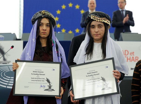 Nadia Murad Basee Taha (L) and Lamiya Aji Bashar, both Iraqi women of the Yazidi faith, pose with the 2016 Sakharov Prize during an award ceremony at the European Parliament in Strasbourg, France, Dec ...