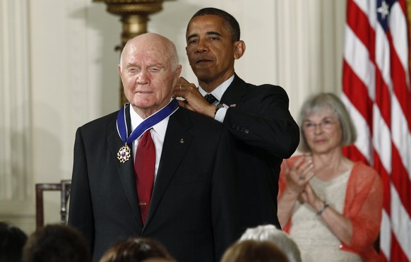 U.S. President Barack Obama awards a 2012 Presidential Medal of Freedom to astronaut and former U.S. Senator John Glenn (L) during a ceremony in the East Room of the White House in Washington, DC, U.S ...