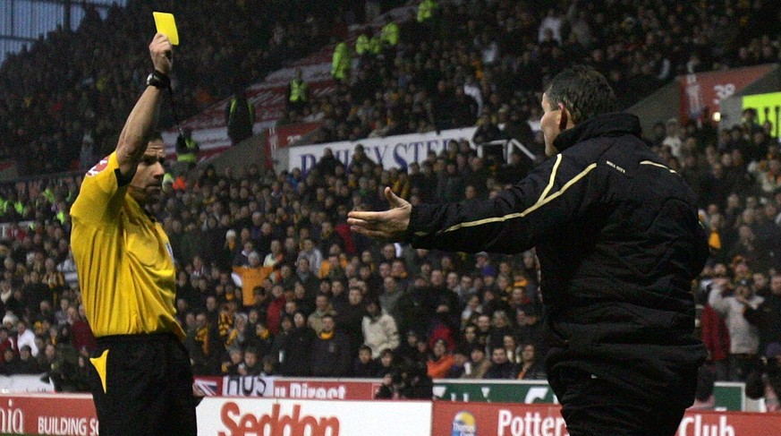 STOKE, UNITED KINGDOM - NOVEMBER 29: Dean Windass of Hull City is booked by referee Keith Stroud for blocking the throw in by Rory Delap of Stoke during the Barclays Premier League match between Stoke ...