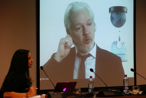 WikiLeaks founder Julian Assange appears on screen via video link during his participation as a guest panelist in an International Seminar on the 60th anniversary of the college of Journalists of Chil ...
