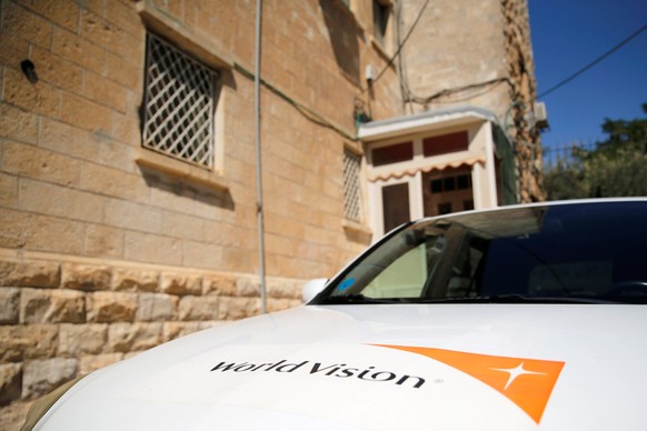 The logo of U.S.-based Christian charity World Vision is seen on a car parked outside their offices in Jerusalem August 4, 2016. REUTERS/Ammar Awad