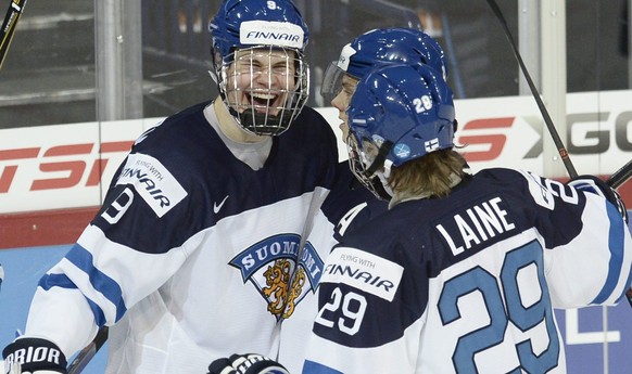 Left to right: Finland&#039;s Jesse Puljujarvi, Sebastian Aho and Patrik Laine celebrate the 4-0 goal by Puljujarvi during the 2016 IIHF World Junior Ice Hockey Championship match Finland vs Belarus i ...